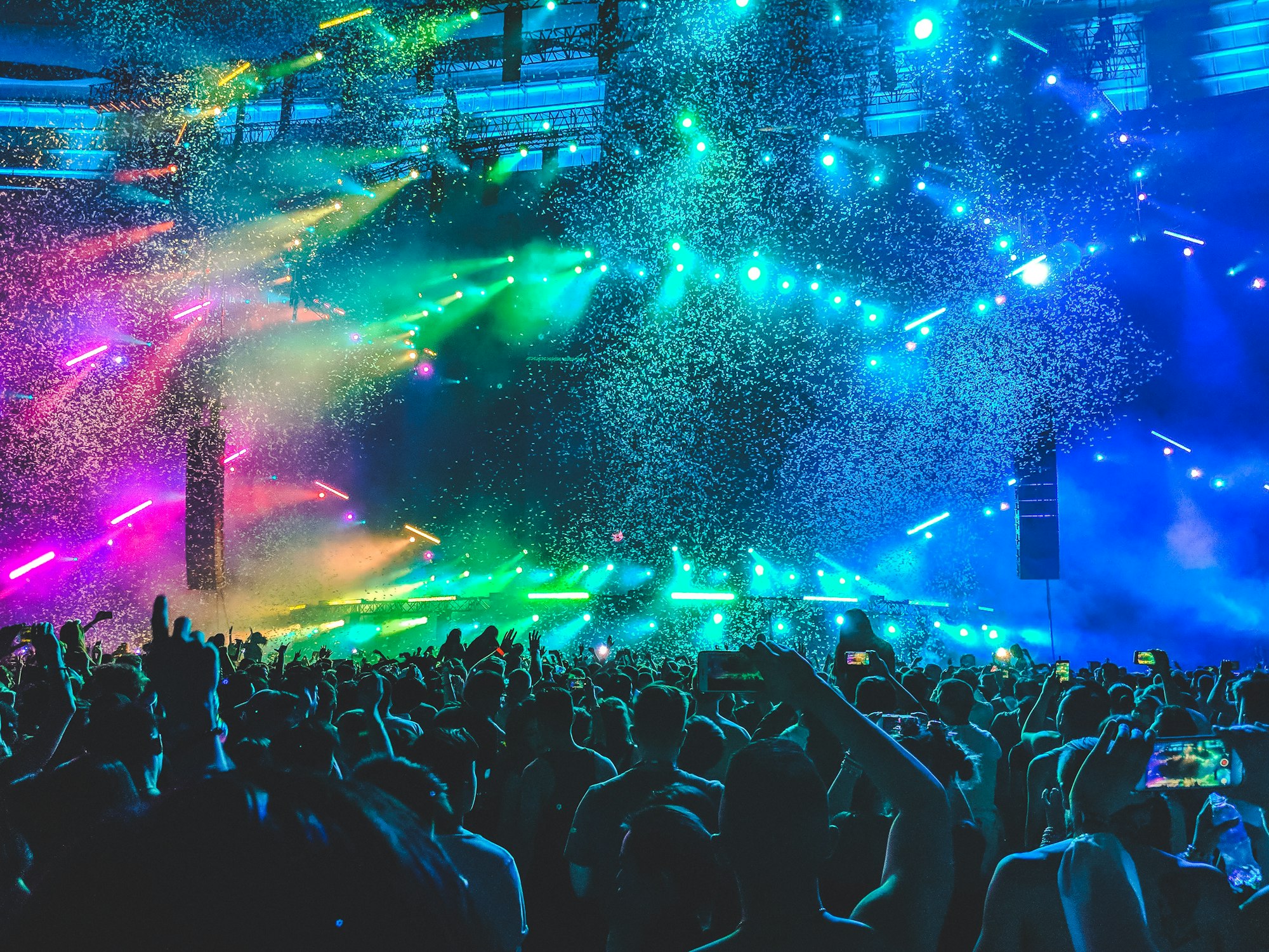 A crowd gathered at an outdoor evening festival under string lights